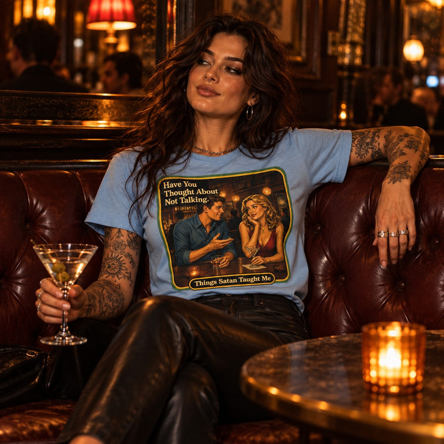 Model sitting in the Have You Thought About Not Talking tee in dusty blue by Things Satan Taught Me