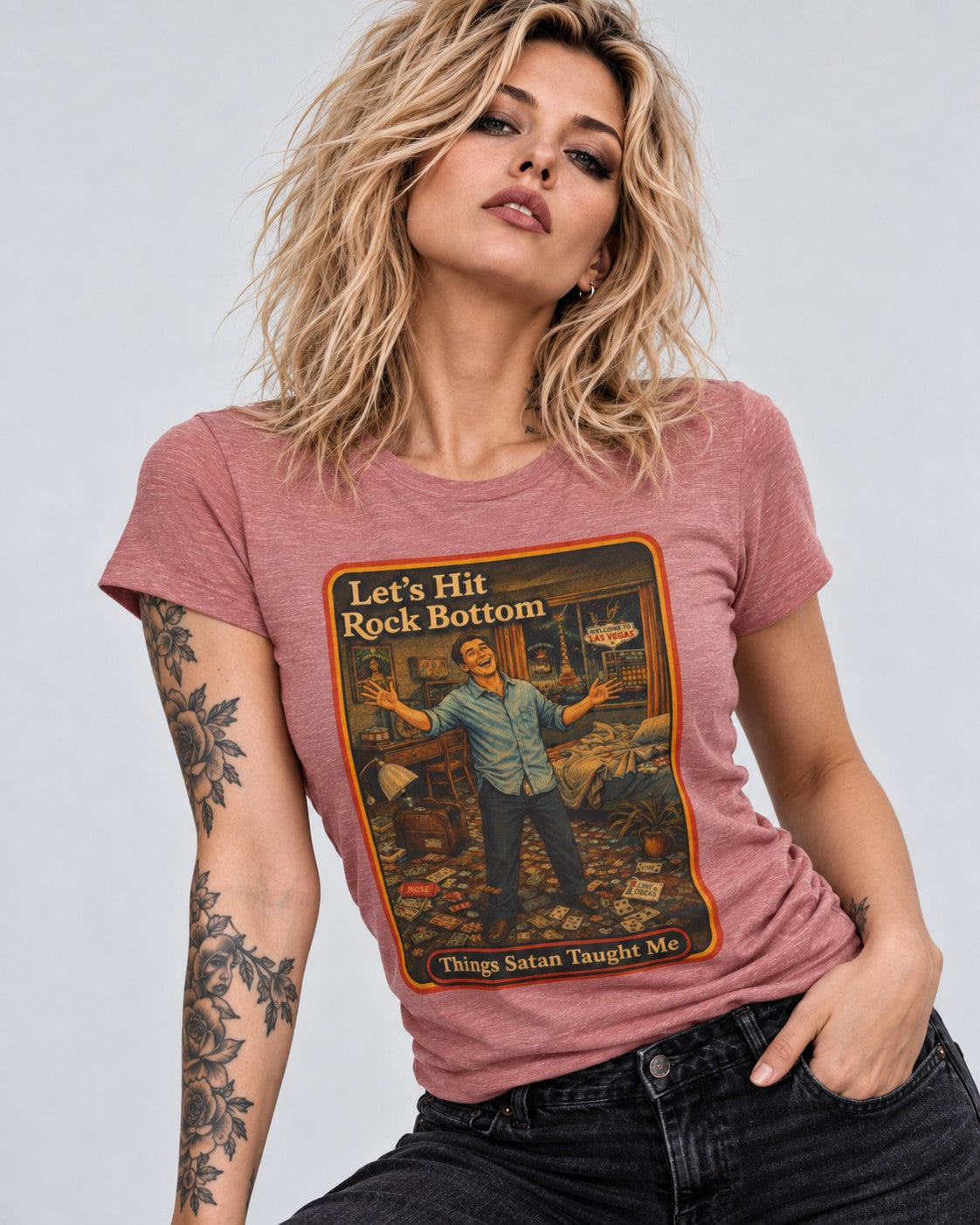 Model wearing the Let's Hit Rock Bottom women's tee in heather mauve by Things Satan Taught Me